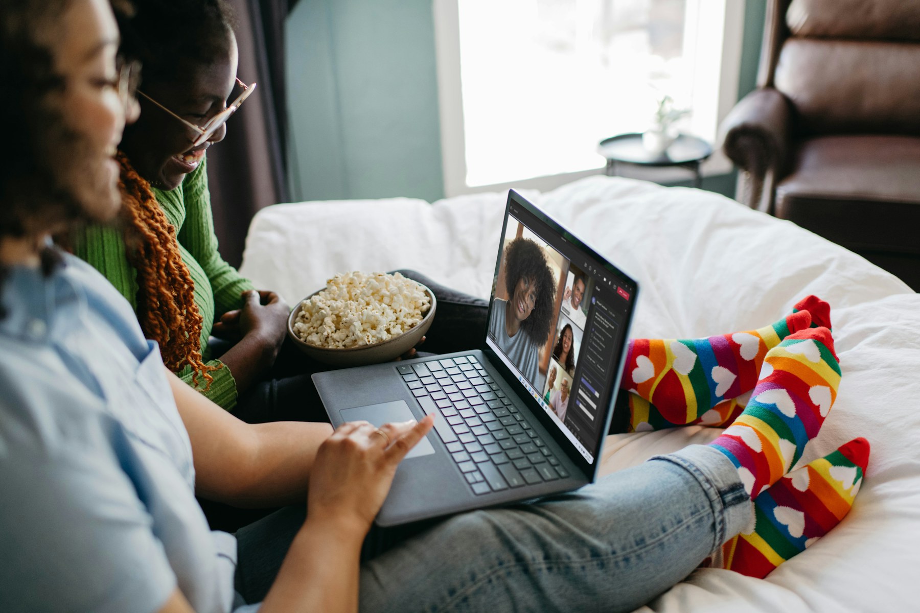 Friends connecting through a group video call at home